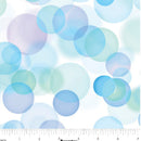Wide quilt backing fabric with a pattern of overlapping translucent circles in soft blue, aqua, mint green, and pale lavender on a white background, with a ruler along the bottom edge showing scale.