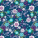 Wide quilt backing fabric with a floral print in white, magenta, lavelnder and aqua with green leaves on a dark blue background.