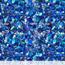 Wide quilt backing fabric with a pattern of blue geometric shapes with a mosaic-like design with a ruler at the bottom to show scale.