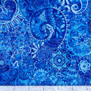 Blue patterned wide quilt backing fabric with a bohemian abstract design with a ruler at the bottom to show scale.