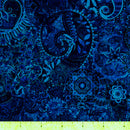 Dark blue wide quilt backing fabric with a bohemian abstract design with a ruler at the bottom to show scale.