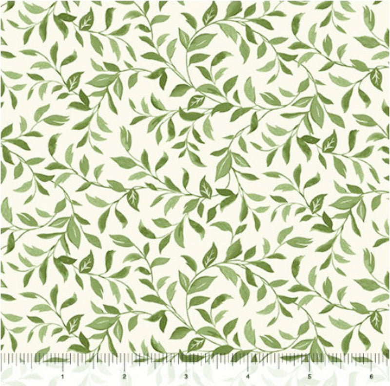 Wide quilt backing fabric with a pattern of green vines with leaves on a cream background.