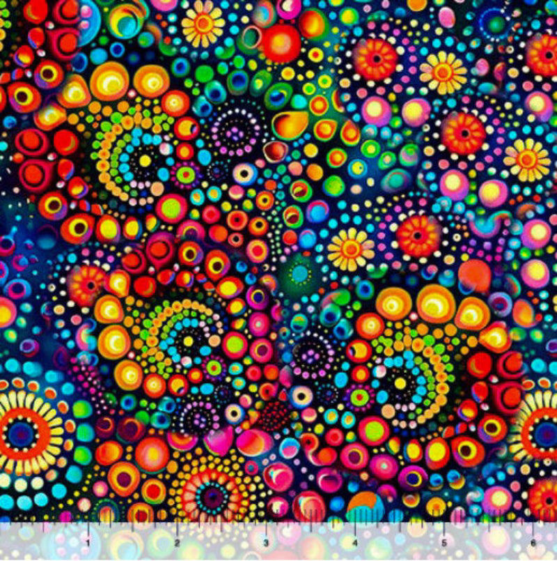 Wide quilt backing fabric with a bright, colorful pattern of concentric circles and swirls on a dark background with a ruler at the bottom for scale.