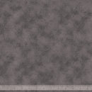 Gray wide quilt backing fabric with a tone on tone textured print and a ruler at the bottom for scale.