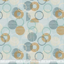 Patterned wide quilt backing fabric with circular shapes in teal, brown cream and white a light teal  background, featuring a ruler at the bottom for scale.