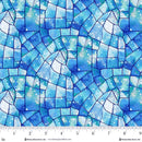 Wide quilt backing fabric with a colorful mosaic pattern in blues with a little greens, and a ruler at the bottom to show scale.