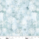 Pattern of white snowflakes on a light teal green background with a ruler at the bottom to show scale.