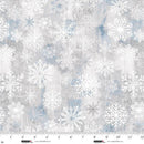 Gray and blue fabric with white snowflakes and a ruler at the bottom to show scale.