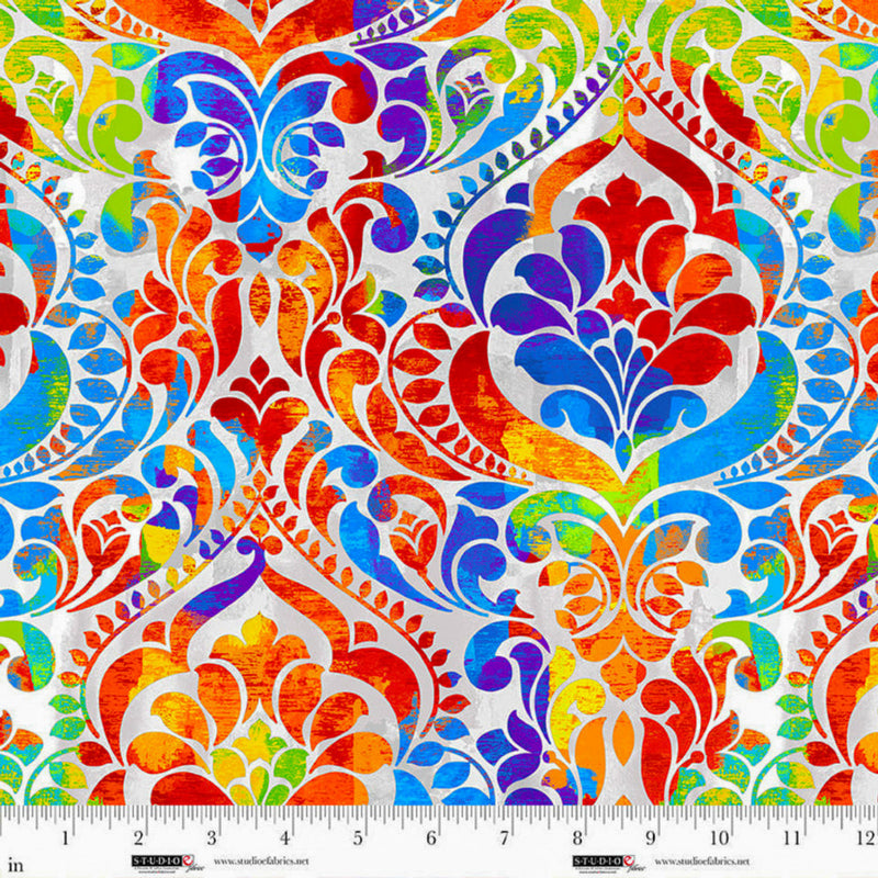 Wide quilt back fabric with a damask print in rainbow colors on a gray and white background.