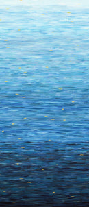 Ombre wide quilt backing fabric that looks like ripples fading from light blue on top to dark blue on the bottom with small yellow accents scattered across the fabric.