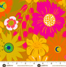 A close-up of a retro 1970s themed floral wide quilt backing fabric pattern featuring bright pink, yellow, orange, and green flowers, leaves, and abstract eye and moon motifs on an orange background, with a white measurement ruler at the bottom showing the scale.