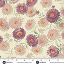 Wide quilt backing fabric with a pattern of purple and lavender flowers with green leaves on a beige background, with a ruler at the bottom to show scale.