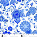 Blue delft-looking floral patterned wide quilt backing fabric on a white background with a ruler at the bottom to show scale.