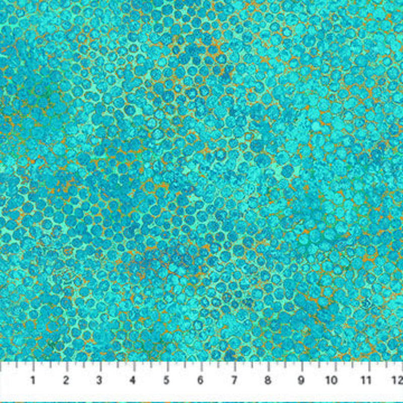 Wide quilt backing fabric with a multicolored, tiny circle pattern with turquoise, aqua, blue, green, and yellow hues with a ruler at the bottom for scale.