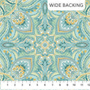 Paisley medallion patterned fabric in teal, blue and yellow with a ruler at the bottom for scale.
