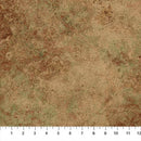 A close-up of a mottled brown, tan and green textured looking wide quilt backing fabric with a ruler along the bottom edge showing measurements in inches.