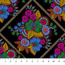 Colorful floral pattern on black wide quilt backing fabric with a diamond motif and a ruler for scale.