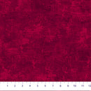 A close-up of a wide quilt backing flannel fabric swatch with a textured looking print in deep red, with a white ruler along the bottom edge showing measurement markings.