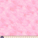 Light pink wide quilt backing fabric with a  tone on tone textured look with a ruler at the bottom to show scale.