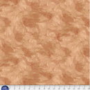 Tan wide quilt backing fabric with a  tone on tone textured look with a ruler at the bottom to show scale.