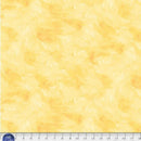 Yellow wide quilt backing fabric with a  tone on tone textured look with a ruler at the bottom to show scale.