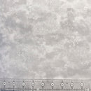 Light gray mottled wide quilt backing fabric, with a transparent ruler along the bottom edge for scale.