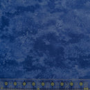 Blue mottled wide quilt backing fabric with a clear ruler along the bottom edge for scale.