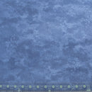 Wide quilt backing fabric with a mottled blue textured looking print, with a clear ruler along the bottom edge showing scale.