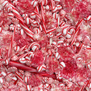 Wide quilt backing fabric with a dense pile of red and white holiday candies, including candy canes, peppermint sticks, round peppermint candies, and pinkish-red flower-shaped sweets, filling the entire frame.