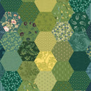 A close-up of the green section of the wide quilt backing fabric made of hexagonal patches in various shades of green, olive, and yellow, featuring different floral and geometric prints.