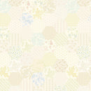 Wide quilt backing fabric with a repeating pastel hexagon print with floral, paisley, and geometric motifs in soft yellow, blue, pink, green and beige on a cream background.