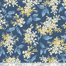 Floral pattern with yellow and white flowers and blue leaves on a navy blue background with a ruler at the bottom to show scale.