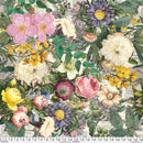 Wide quilt backing fabric with a vintage large floral multi colored design on a vintage newspaper background with a ruler at the bottom for scale.