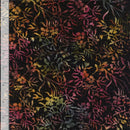 Batik wide quilt backing fabric with a multi colored allover floral vine and leaf print on a black background with a ruler on the side to show scale.