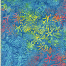 Floral and leaf print batik fabric in yellow, orange and red on a medium blue background.
