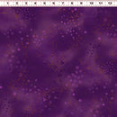 Purple patterned wide quilt backing fabric with scattered stars, triangles, spirals, and yellow glitter-like speckles, shown with a ruler at the top for scale.