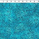 Wide quilt backing fabricwith a repeating spiral pattern in turquoise, teal, and dark blue, with a ruler along the top edge showing measurements.